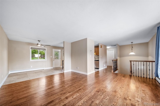 8051 S Kendall Blvd, Littleton, CO 80128 - unfurnished living room featuring a baseboard heating unit, a ceiling fan, and light wood-type flooring