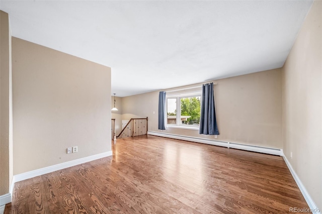8051 S Kendall Blvd, Littleton, CO 80128 - unfurnished living room featuring baseboard heating and wood finished floors