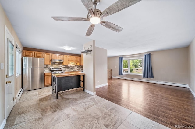 8051 S Kendall Blvd, Littleton, CO 80128 - kitchen featuring stainless steel appliances, a baseboard heating unit, butcher block counters, and tasteful backsplash