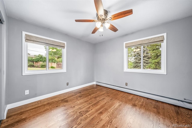 8051 S Kendall Blvd, Littleton, CO 80128 - empty room featuring a baseboard heating unit, plenty of natural light, wood finished floors, and a ceiling fan