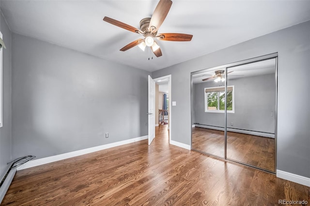 8051 S Kendall Blvd, Littleton, CO 80128 - unfurnished bedroom with a baseboard radiator, wood finished floors, a closet, and a ceiling fan