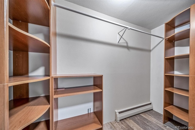 8051 S Kendall Blvd, Littleton, CO 80128 - walk in closet with a baseboard radiator and wood finished floors