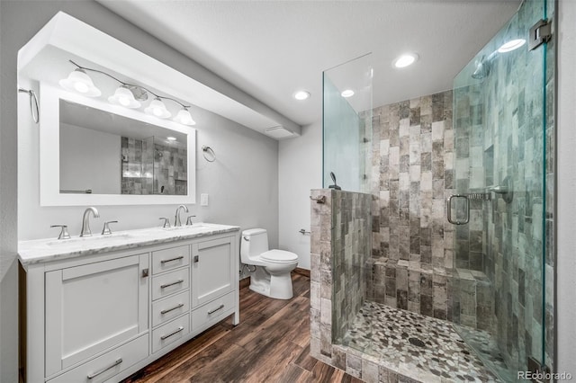 8051 S Kendall Blvd, Littleton, CO 80128 - bathroom with recessed lighting, a shower stall, double vanity, and wood finished floors
