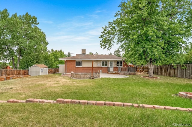 8051 S Kendall Blvd, Littleton, CO 80128 - back of house with brick siding, a patio, a fenced backyard, and a shed