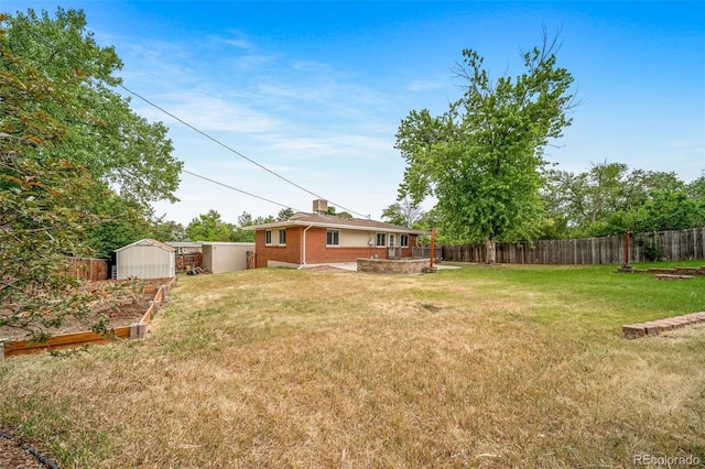 8051 S Kendall Blvd, Littleton, CO 80128 - fenced backyard with a storage shed and a garden