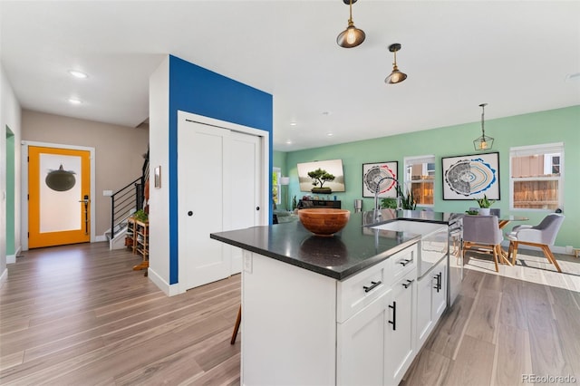 550 S Raleigh St, Denver, CO 80219 - kitchen with light wood-style flooring, white cabinetry, decorative light fixtures, recessed lighting, and a kitchen island with sink
