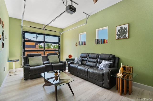 550 S Raleigh St, Denver, CO 80219 - living area with wood finished floors, a garage, and a textured wall