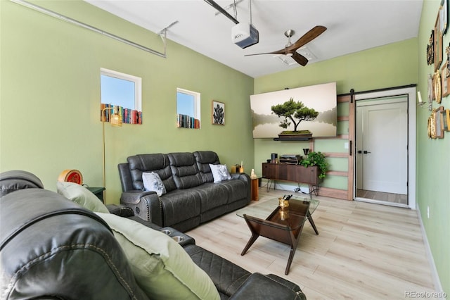 550 S Raleigh St, Denver, CO 80219 - living area with a barn door, wood finished floors, and a ceiling fan