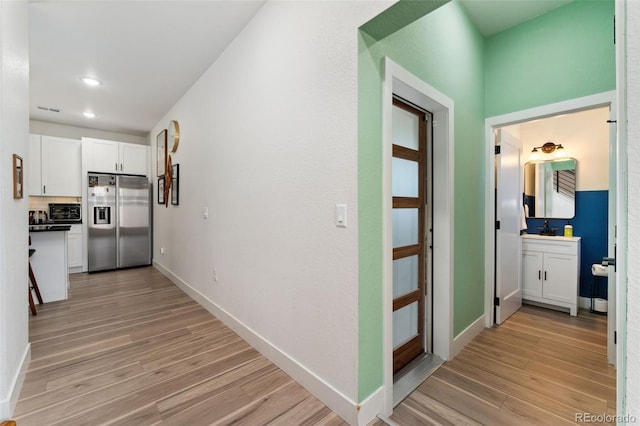550 S Raleigh St, Denver, CO 80219 - corridor with light wood-style flooring and recessed lighting