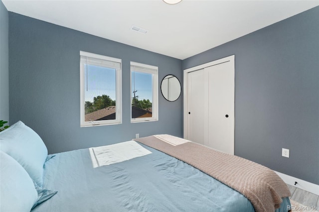 550 S Raleigh St, Denver, CO 80219 - bedroom featuring wood finished floors and a closet