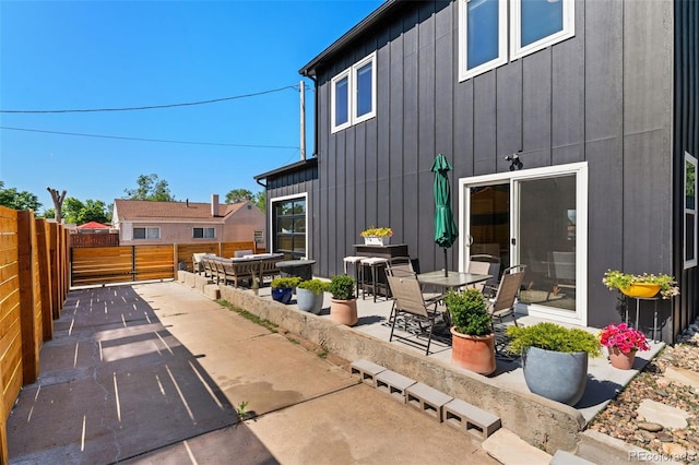 550 S Raleigh St, Denver, CO 80219 - back of house with board and batten siding, a patio area, and a fenced backyard