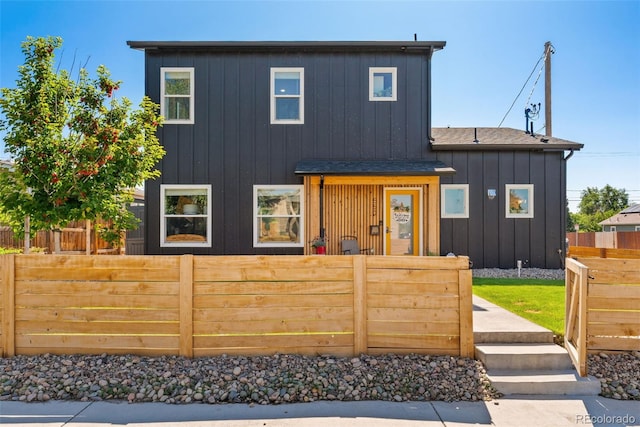 550 S Raleigh St, Denver, CO 80219 - view of front of property with board and batten siding and a fenced front yard