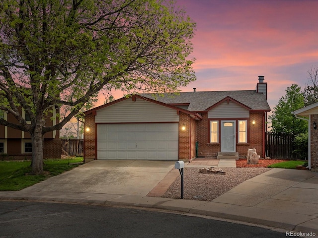 view of front of property featuring fence, a garage, concrete driveway, a chimney, and brick siding