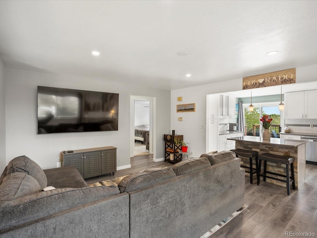 living area featuring wood finished floors, recessed lighting, and baseboards