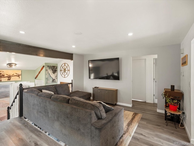 living area with wood finished floors, baseboards, and recessed lighting