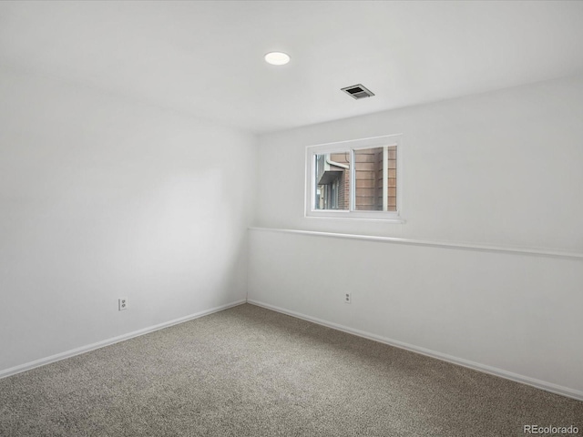 carpeted empty room featuring baseboards and recessed lighting