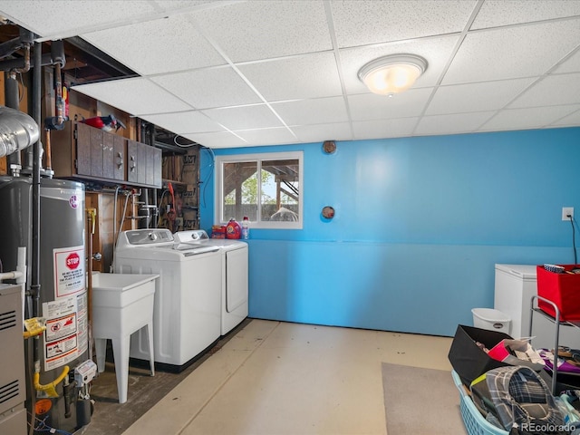 clothes washing area featuring separate washer and dryer and gas water heater