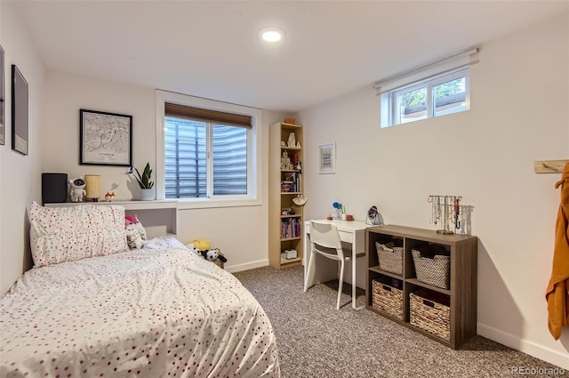 carpeted bedroom featuring baseboards