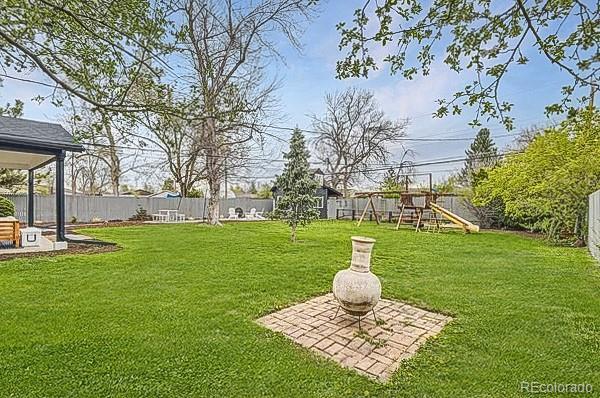 view of yard featuring a playground and a fenced backyard