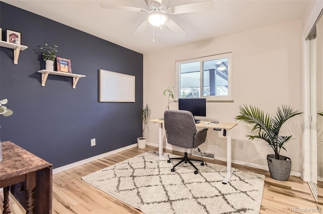 office featuring a ceiling fan, baseboards, and wood finished floors