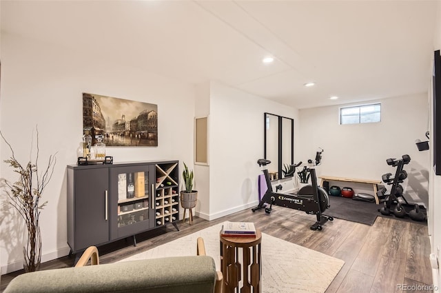 exercise room with recessed lighting, baseboards, and wood finished floors