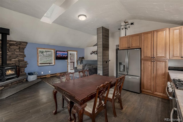 54 Zaza Ln, Evergreen, CO 80439 - dining area featuring vaulted ceiling, dark wood-style flooring, and a wood stove