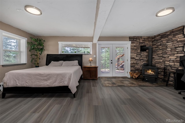 54 Zaza Ln, Evergreen, CO 80439 - bedroom featuring french doors, access to outside, a wood stove, wood finished floors, and beam ceiling