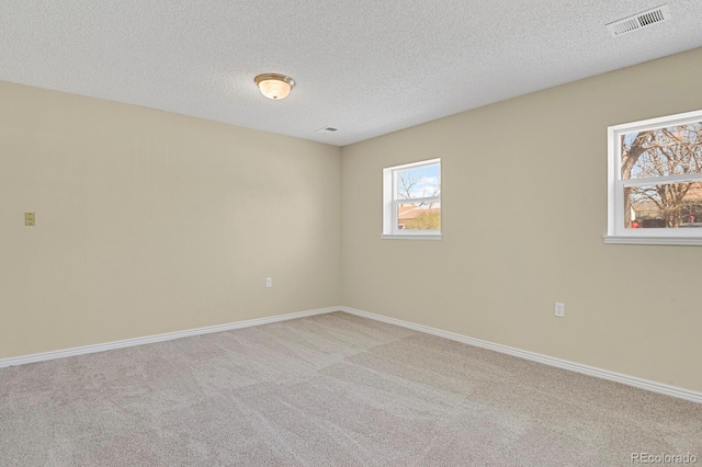 243 Madison Dr, Bennett, CO 80102 - carpeted spare room with baseboards, visible vents, and a textured ceiling