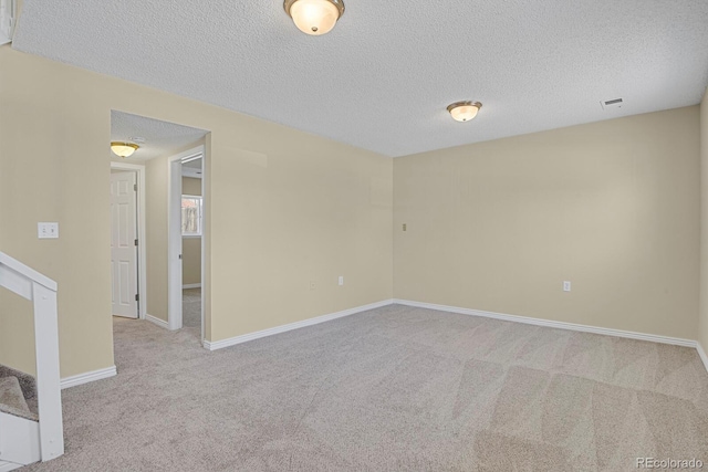 243 Madison Dr, Bennett, CO 80102 - unfurnished room with visible vents, baseboards, carpet floors, and a textured ceiling