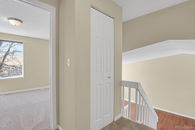 243 Madison Dr, Bennett, CO 80102 - hallway with carpet floors, an upstairs landing, and baseboards