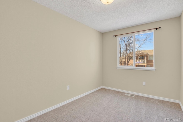 243 Madison Dr, Bennett, CO 80102 - carpeted empty room featuring a textured ceiling, visible vents, and baseboards