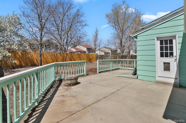 243 Madison Dr, Bennett, CO 80102 - view of patio featuring a fenced backyard and a residential view