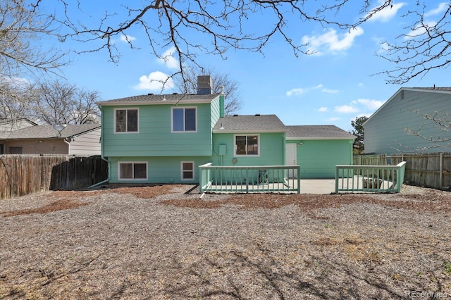 243 Madison Dr, Bennett, CO 80102 - rear view of house with a chimney and a fenced backyard