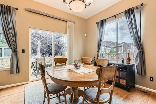10463 Nucla St, Commerce City, CO 80022 - dining area with plenty of natural light, light wood finished floors, and a chandelier