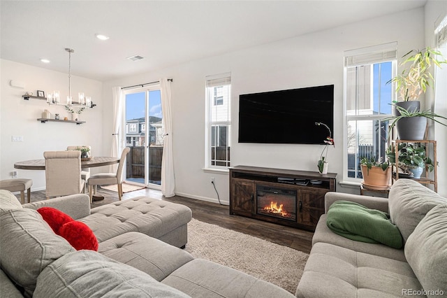 living room with hardwood / wood-style flooring and a chandelier