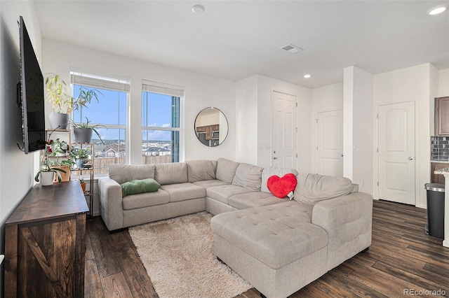 living room with dark wood-type flooring, recessed lighting, and visible vents