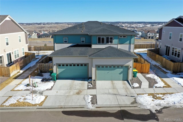 traditional-style home with driveway, fence, a residential view, a shingled roof, and a garage