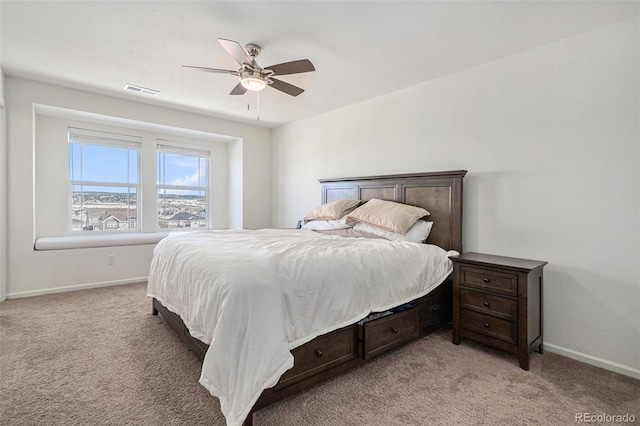 bedroom with visible vents, light colored carpet, a ceiling fan, and baseboards