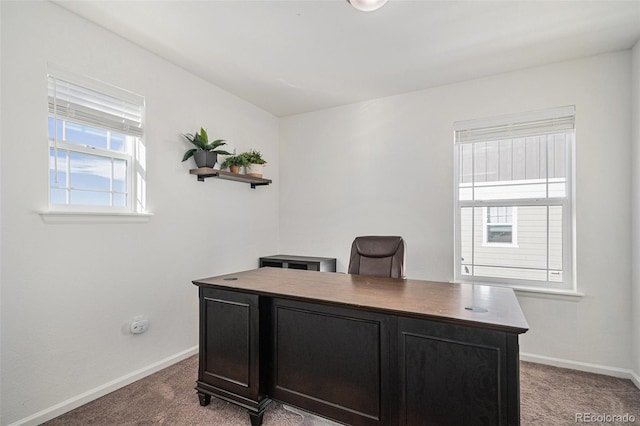 carpeted home office featuring baseboards