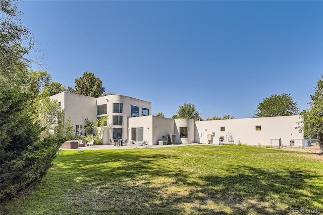 rear view of house with a yard, central AC unit, and a patio area