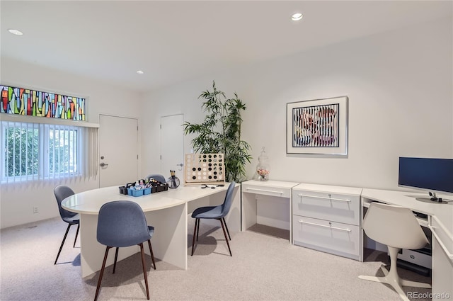 carpeted home office featuring built in desk