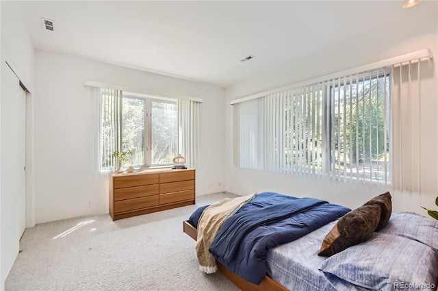 bedroom featuring light colored carpet