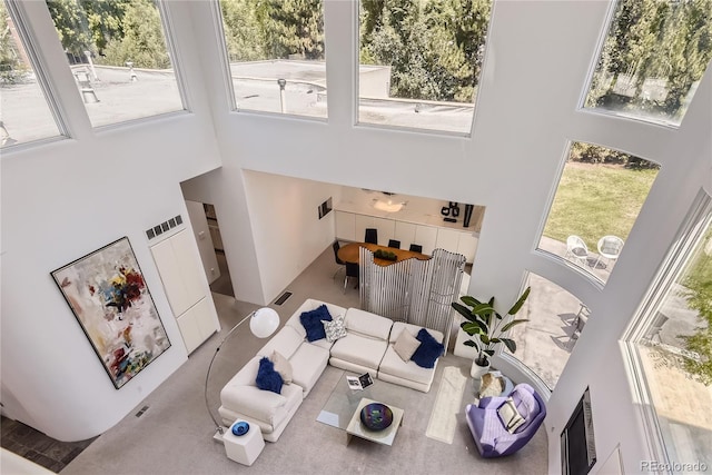 living room featuring a towering ceiling