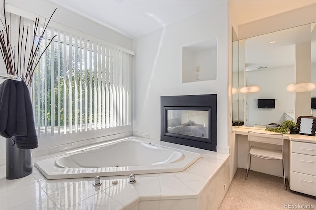 bathroom featuring a relaxing tiled tub and a multi sided fireplace