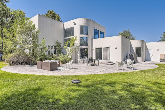 back of house featuring a yard, outdoor lounge area, and a patio area