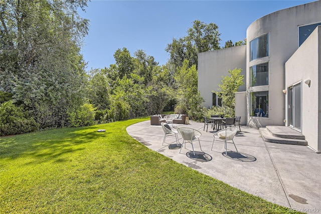 view of yard with outdoor lounge area and a patio