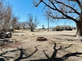 view of yard with a fire pit