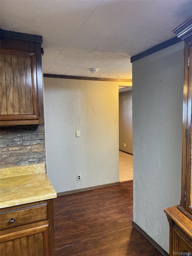 interior space featuring dark hardwood / wood-style flooring and backsplash