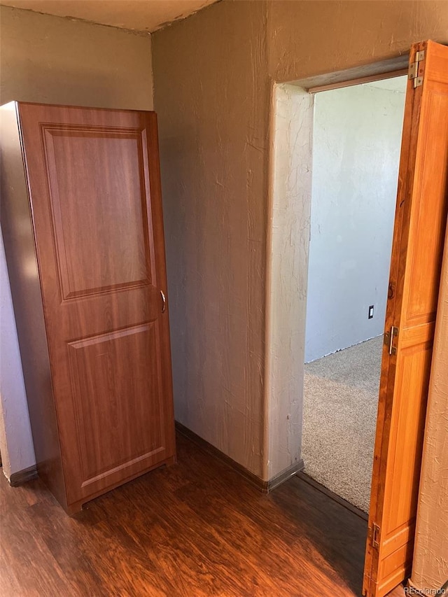 corridor with dark hardwood / wood-style floors