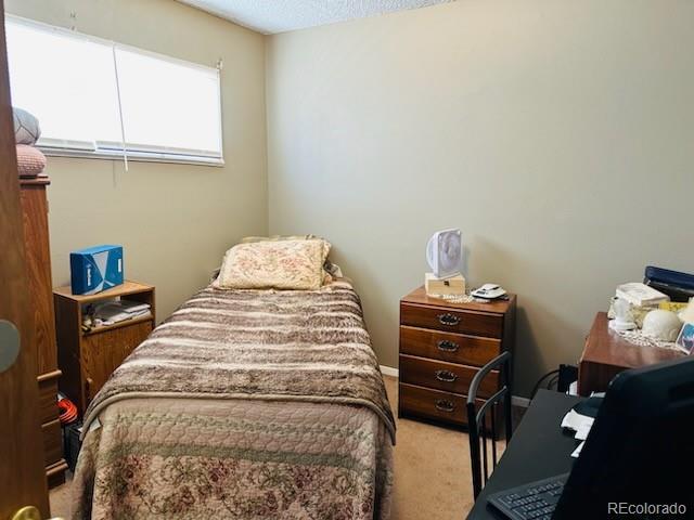 carpeted bedroom with a textured ceiling